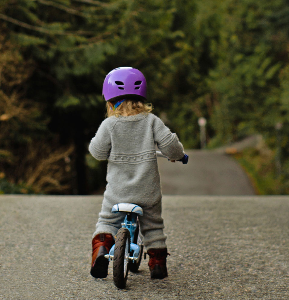 Little girl on a bicycle on a cement path Titan America